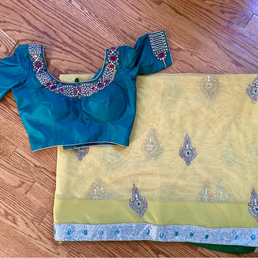 Beautiful yellow net saree with crystal motifs and sequin border